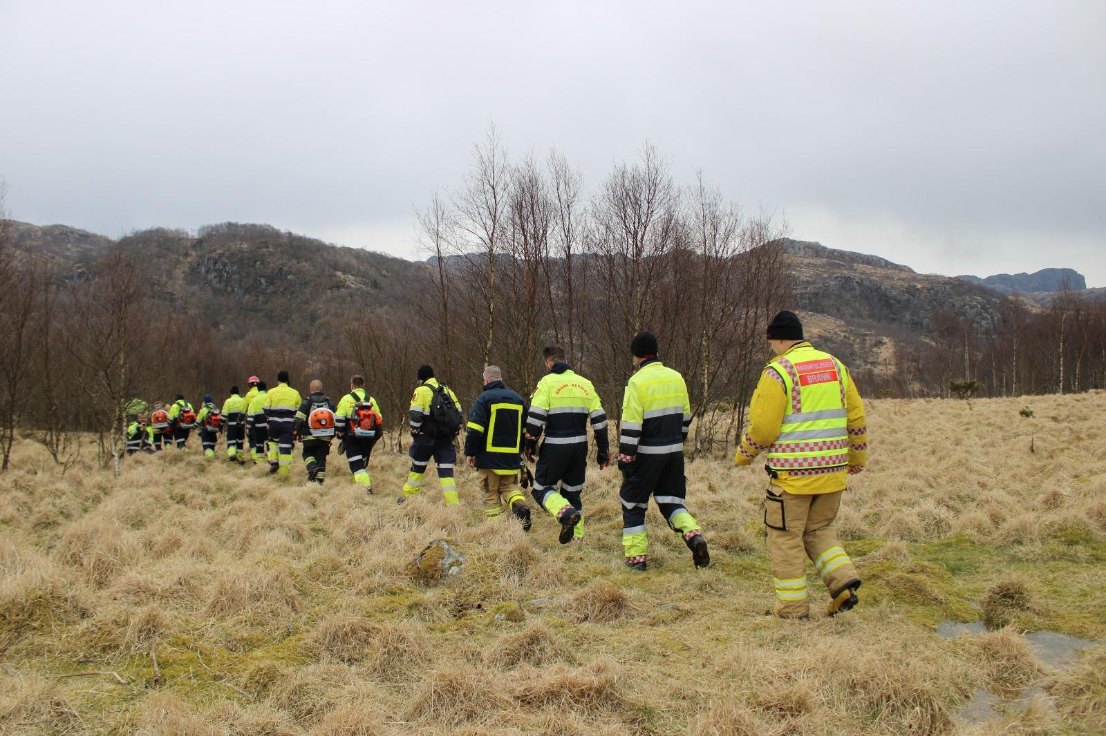 Norwegian wildfire response team walking through dry grassland